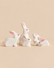 A Bumbu Handmade Wooden White Bunny Rabbit Family Set of five small, hand-painted wooden rabbits in varying sizes, each an eco-friendly toy in white with pink-lined ears.