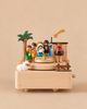 A Nativity Scene Music Box featuring a nativity scene with Mary, Joseph, the baby Jesus, a palm tree, a star, and a sheep on a rotating platform.