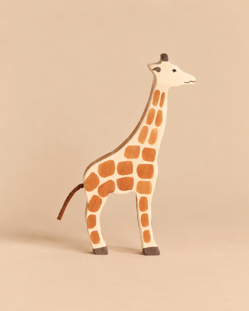 Holztiger Giraffe handcrafted wooden toy with a brown spot pattern and a string tail.