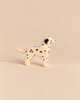An Ostheimer Dog - Dalmatian handcrafted wooden dog toy with black spots and a black ear.