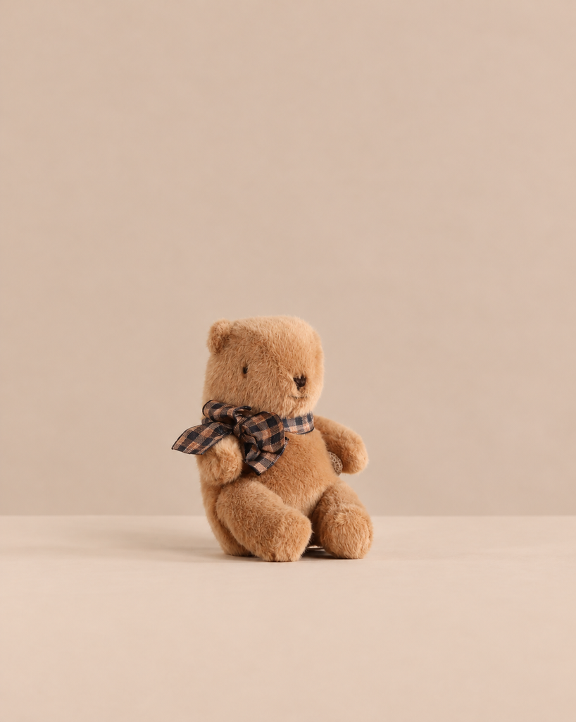 Maileg Teddy Bear Plush, Mini - Mushroom is a huggable small brown teddy bear wearing a plaid neck scarf.