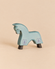 An Ostheimer Blue Horse for Knight handcrafted from wood, featuring a light blue body, purple fleur-de-lis emblems on its flanks, and dark brown hooves.