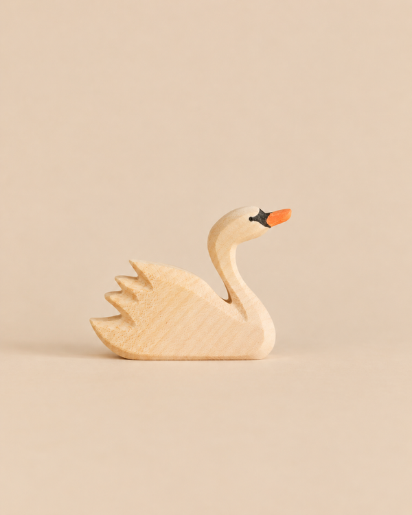 An Ostheimer Swan, Head High, handcrafted from wood with a painted orange beak and black eye detail.