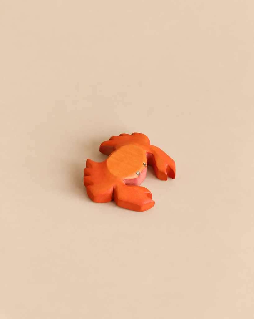 Small, orange-painted Handmade Holzwald Crab wooden toy.