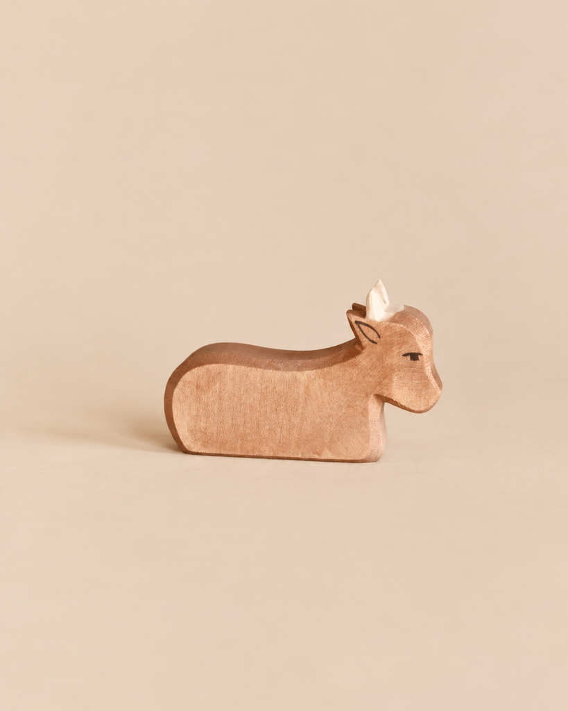 Hand-carved Ostheimer Ox wooden toy in a resting position.