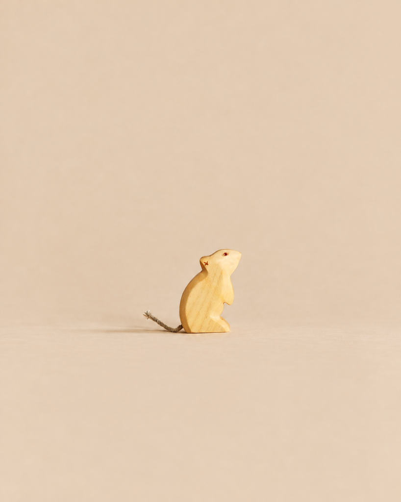 A small, sustainable Handmade Holzwald Mouse - Standing carved in a standing pose with a simple string tail.