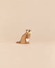 Handcrafted Ostheimer Raccoon - Sitting wooden figurine of a sitting raccoon with a striped tail.