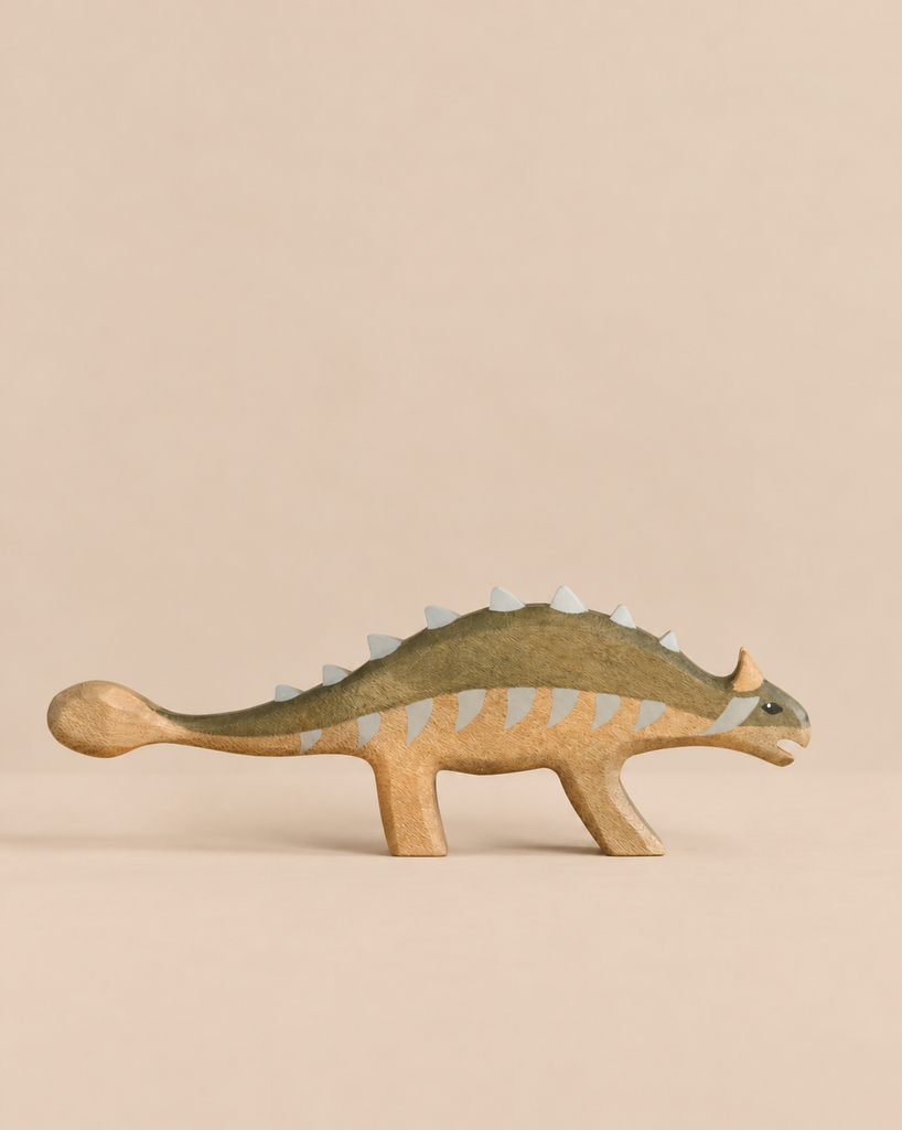 Handmade Holzwald Dinosaur - Ankylosaurus toy with an olive-green back and grey spikes along its spine.