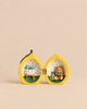 The Konges Sloejd Mini Surprise House - Lemon is a hinged ornament that opens to reveal a miniature world with a tea table on one side and a teddy bear with gifts on the other.