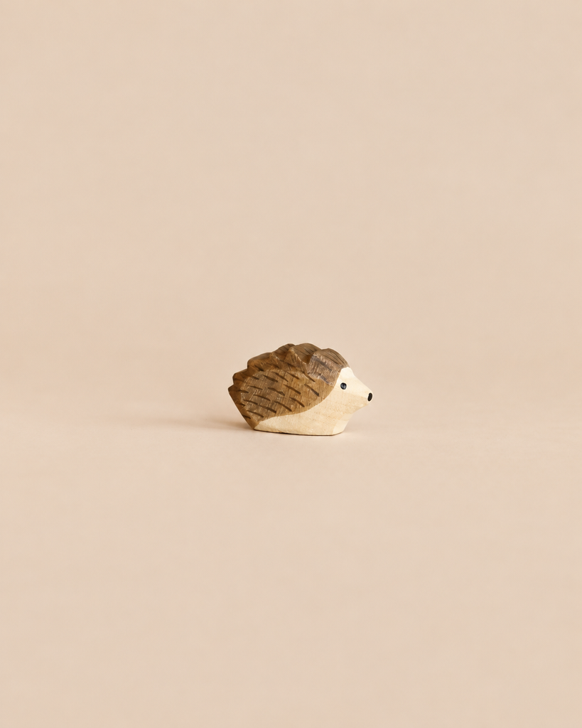 Small Ostheimer Hedgehog - Small handcrafted wooden figurine with a dark brown back and a light natural wood underside, perfect for imaginative play.