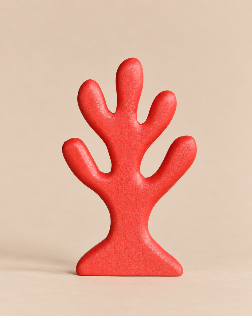 A stylized Handmade Holzwald Red Coral wooden sculpture in the shape of a red coral branch.