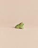 Ostheimer Frog Sitting, a small handcrafted wooden frog in a seated position with a green body and a red eye.