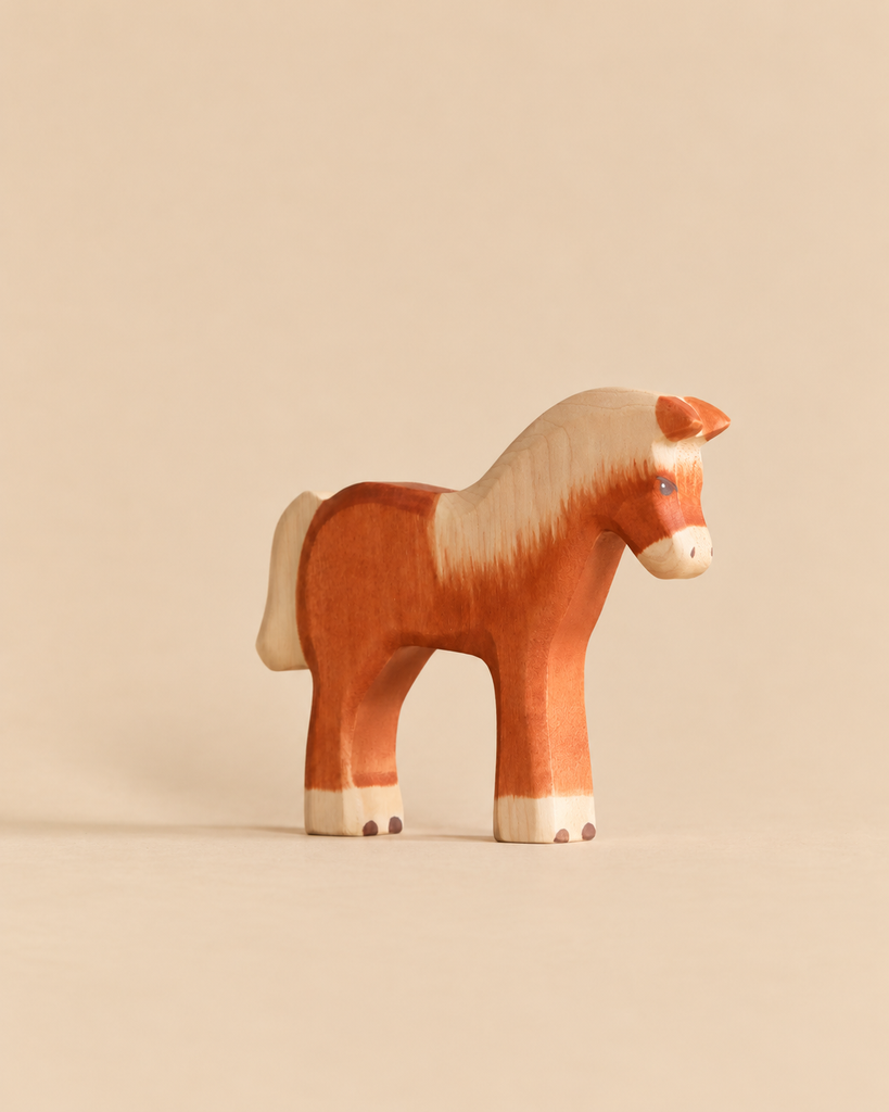 Handmade Holzwald Farm Animals Set wooden toy horse with a brown and cream coat, crafted in the style of sustainable Holzwald animals.