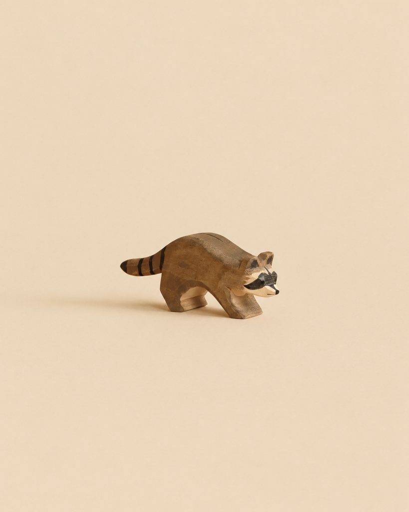 Handcrafted Ostheimer Raccoon Running wooden toy figurine in a running pose.