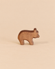 A handcrafted wooden Ostheimer Small Bear - Running figurine in a standing position, perfect for imaginative play.