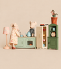 Two Maileg mice in a Maileg Kitchen Set with Grandma & Grandpa, featuring a stove, refrigerator, hutch, and floor lamp with mouse-size furniture.