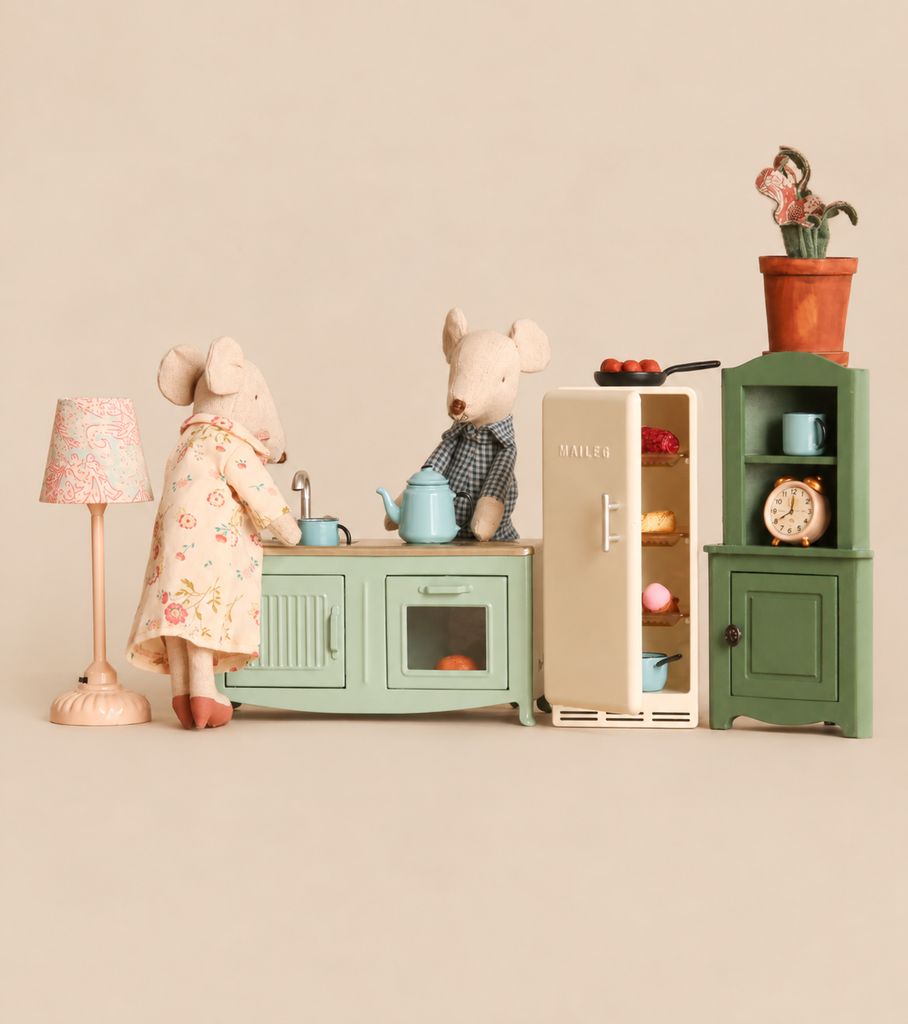 Two Maileg mice in a Maileg Kitchen Set with Grandma & Grandpa, featuring a stove, refrigerator, hutch, and floor lamp with mouse-size furniture.