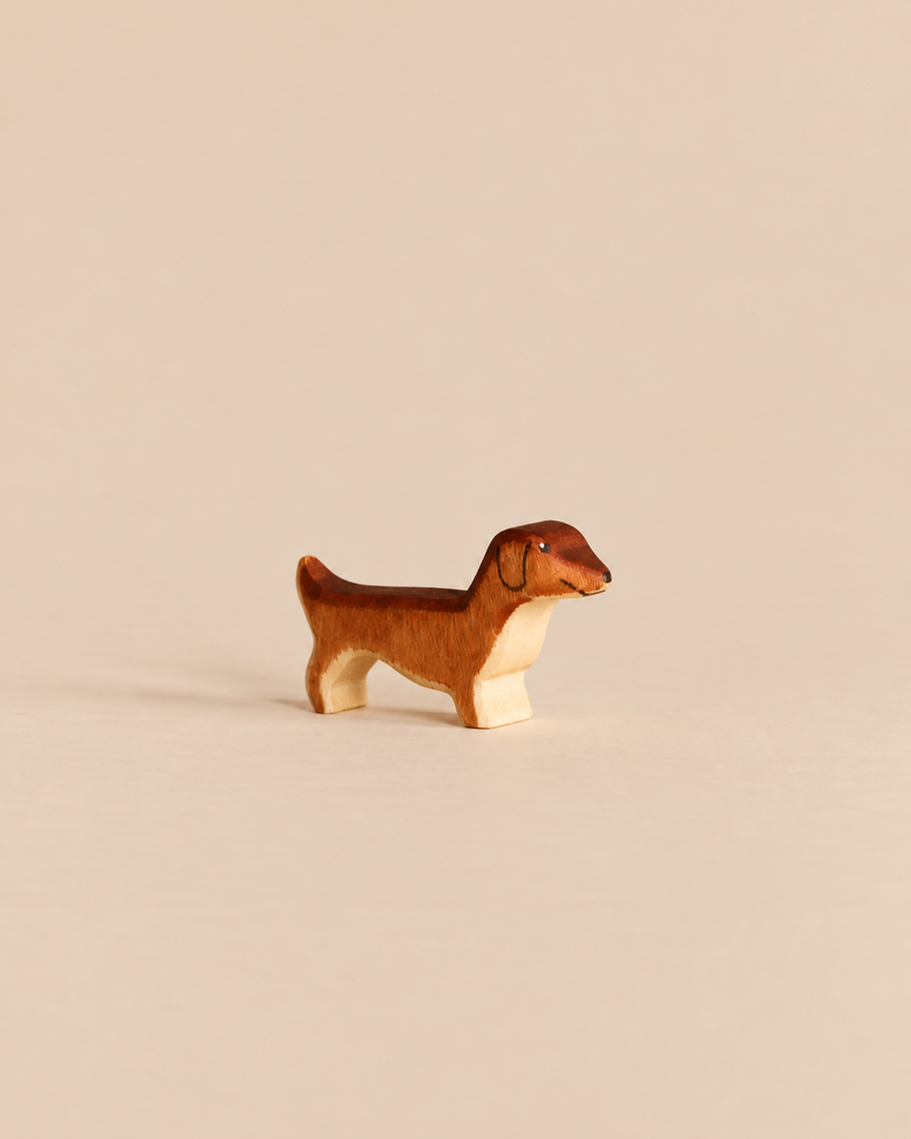 Small, sustainable Handmade Holzwald Dog - Dachshund, Small figurine with brown and tan markings.