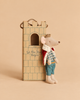 A Maileg King Mouse, Dad, wearing a crown and cape, stands next to a cardboard tower box from the Castle Hall collection labeled “Let the Story Begin.”