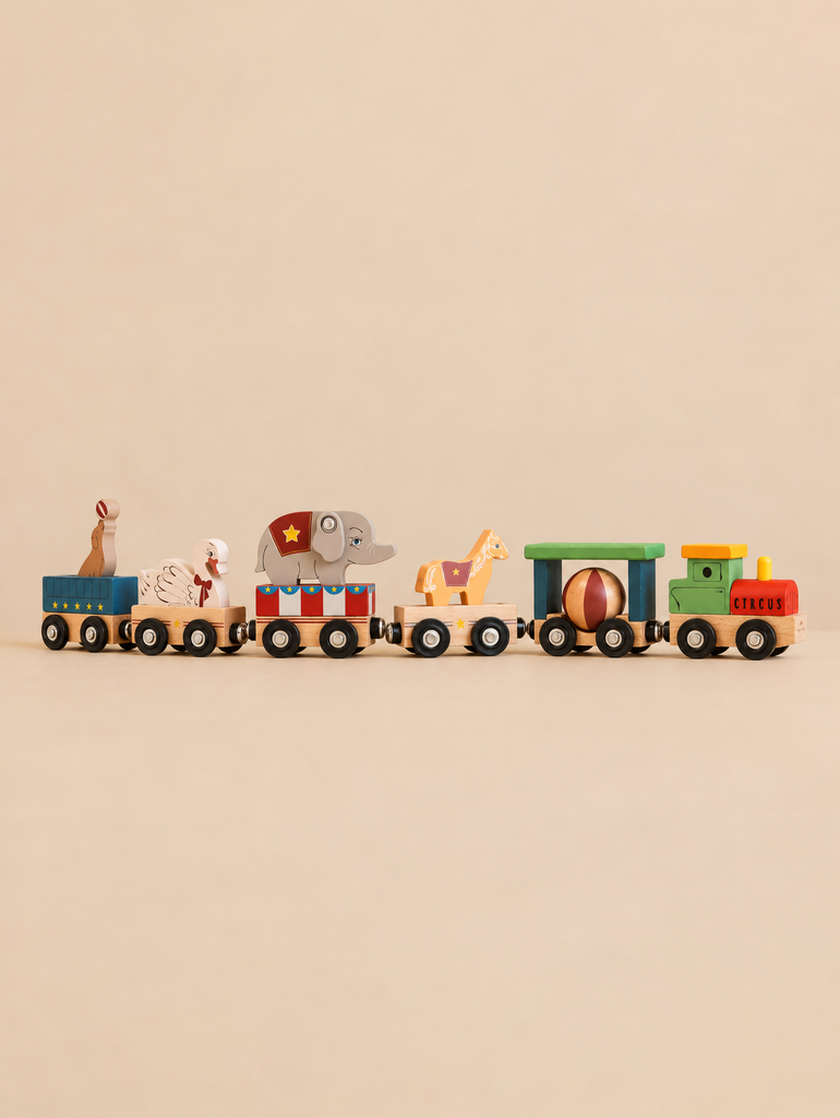 Konges Sloejd Wooden Animal Train featuring a green engine and carriages with a striped ball, a horse, an elephant, a goose, and a sea lion on a pedestal.