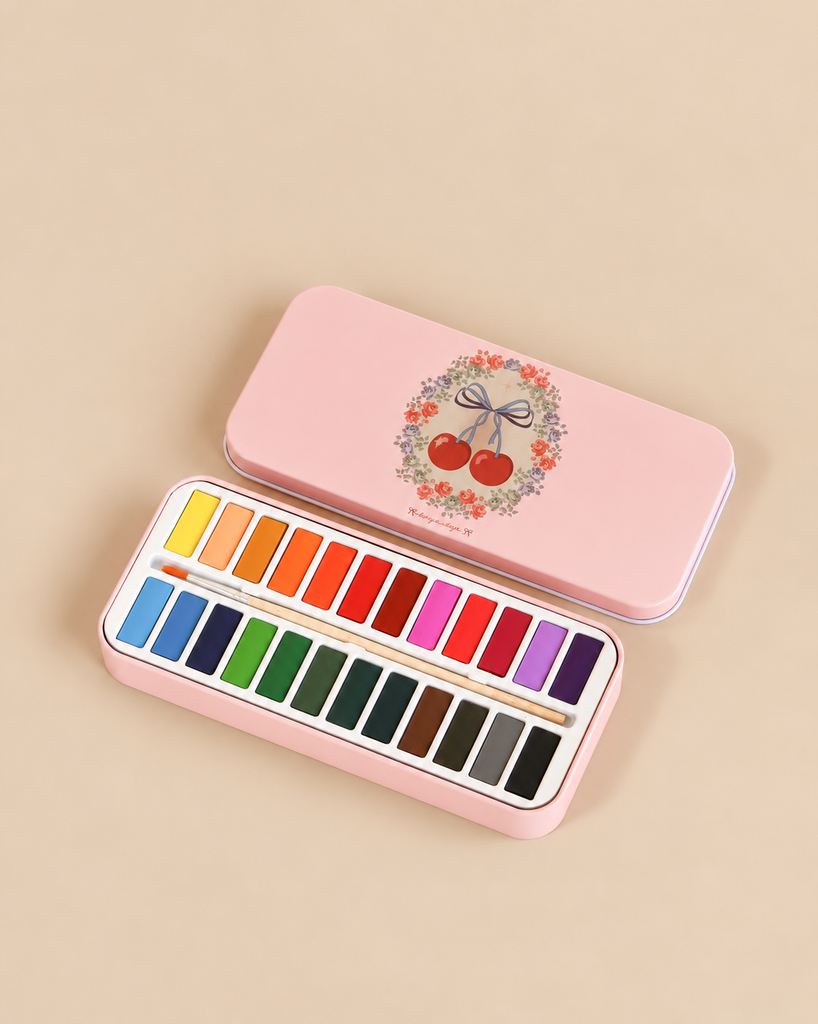 Konges Sloejd Water Colors Paint Set - Cherry Bow in a rectangular metal tin featuring a cherry and floral wreath illustration, containing two rows of colorful paint pans and a brush.