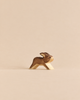 A small wooden Handmade Holzwald Rabbit - Running figurine in a running pose, perfect for sustainable imaginative play.