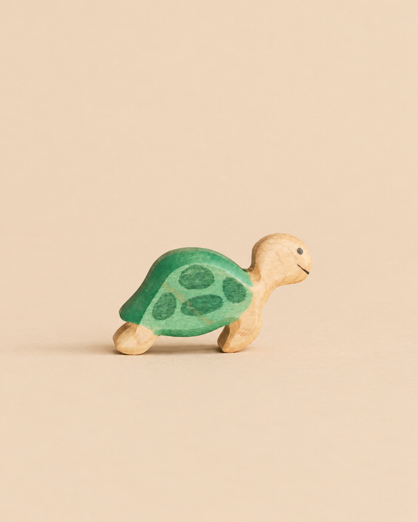 Handmade Holzwald Sea Turtle figurine with a green shell painted with darker spots.