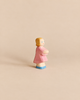 Handcrafted Ostheimer Daughter in Pink Dress wooden figurine of a girl with blonde hair, a pink dress, and blue shoes.