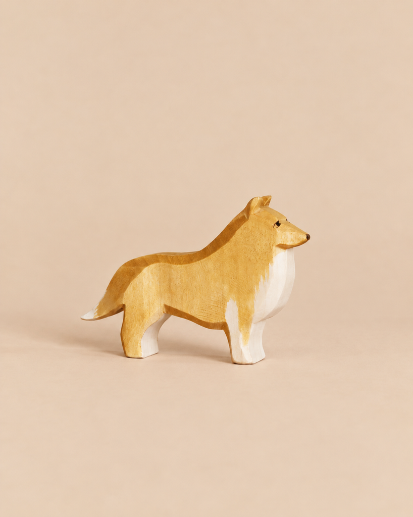 Ostheimer Dog - Collie Dog, a handcrafted wooden figurine of a standing dog with a tan and white coat, made from sustainably sourced materials.