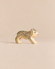 Handmade Holzwald Small Snow Leopard, a hand-carved wooden toy with painted spots and a string tail, designed for imaginative play.