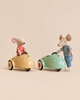 The Maileg Big Brother LouiMax and Big Sister Stella Adventure Set features two mice in striped shirts, one sitting in a yellow toy car and one standing next to a green toy car.