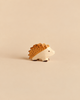 A Holztiger Hedgehog handcrafted wood toy with a brown-painted back and natural wood finish.