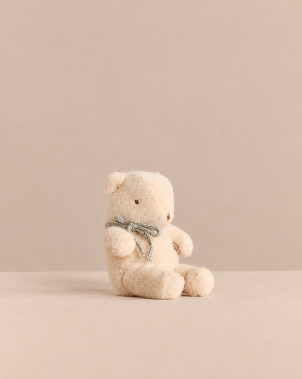 Maileg Teddy Bear Plush, Mini - Off White vintage teddy bear with a small grey ribbon around its neck.