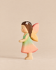 Handmade Holzwald Maya Fairy wooden toy wearing a green and pink dress, featuring brown hair with a white flower accessory and pink wings.