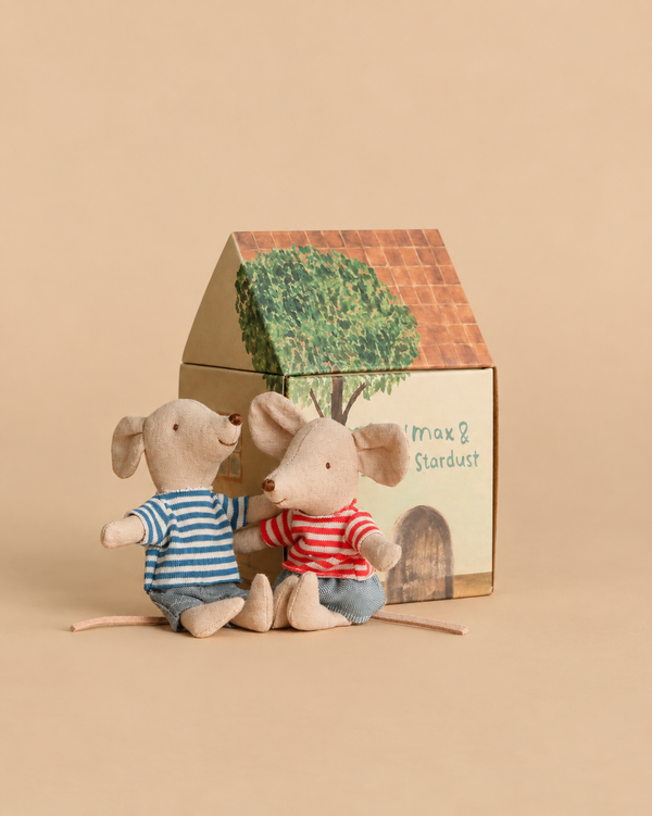 Maileg LouiMax and Stella, Little Brother and Sister Mice wearing striped shirts and blue pants sit in front of a small SuitCasa cardboard house.