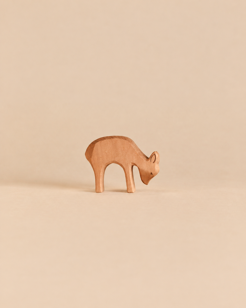 Handcrafted wooden Ostheimer Deer - Eating figurine of a deer with its head lowered as if grazing.
