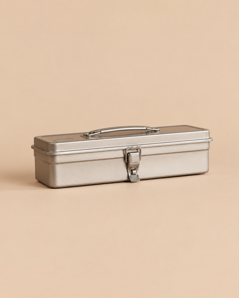A Multi-Purpose Steel Storage Tool Box T-320 - SIlver, featuring a rectangular silver metal body, a carrying handle, and a central latch.