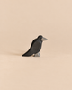 Handcrafted Ostheimer Bird - Raven wooden figurine shown in profile.