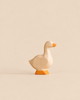 A Handmade Holzwald Goose, a small wooden toy for imaginative play with a painted orange beak and feet.