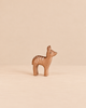 An Ostheimer Deer - Red Fawn, Standing, a small, handcrafted wooden toy in a standing position with painted white spots on its back for imaginative play.