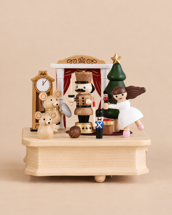 Nutcracker Ballet Music Box featuring figures from The Nutcracker, including a nutcracker, two mice, a ballerina, and small soldiers standing on a base with a Christmas tree and grandfather clock.