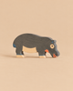 Holztiger Hippopotamus, Feeding, a handcrafted wooden toy in a grazing pose, featuring grey skin with light wood accents on its belly and feet.