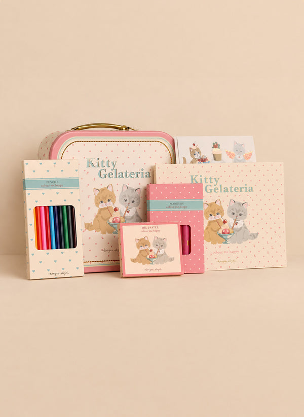 A Konges Sloejd Little Artist Set - Kitty Friends featuring a metal tin, coloring pencils, markers, oil pastels, and a sketchbook, all decorated with illustrations of kittens eating ice cream.