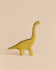A yellow Handmade Holzwald Dinosaur Set toy with a long neck.