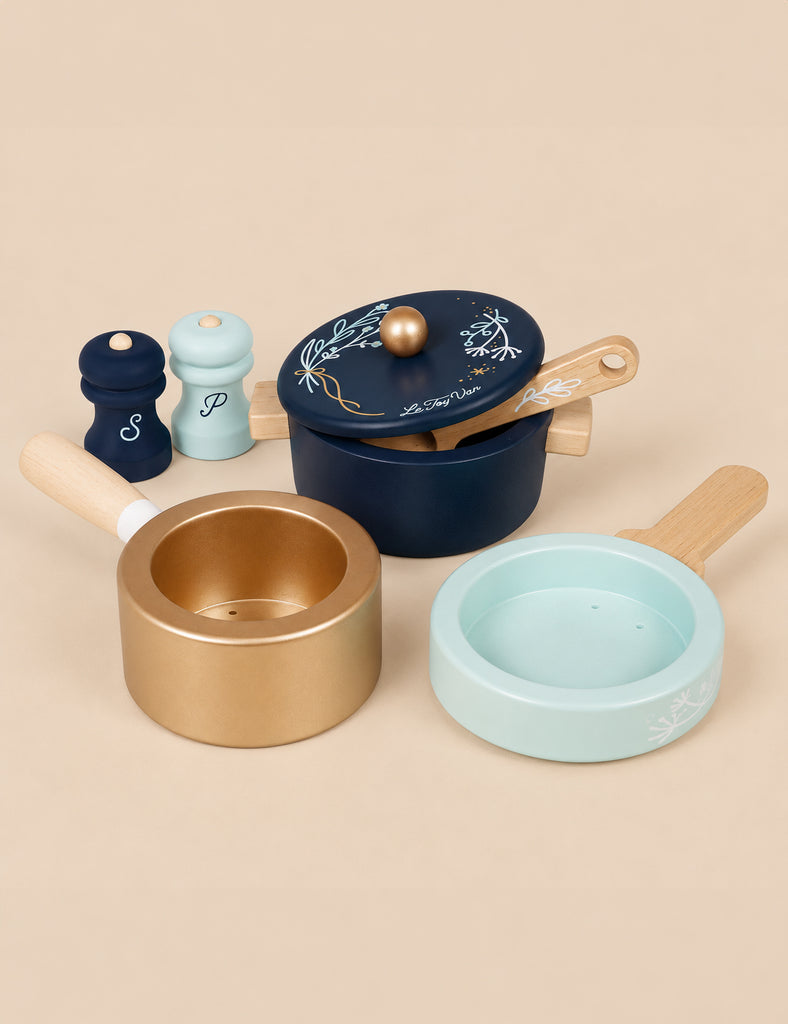 Pots & Pans Kitchen Accessories set featuring a navy blue pot with a lid, a gold pan, a light blue pan, and salt and pepper shakers for pretend play.