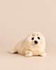 A realistic White Seal Stuffed Animal lying down.