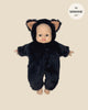 An 11-inch Minikane Babies doll is dressed in a Black Faux Fur Costume from the Minikane Doll Clothing line, featuring a fluffy black bear design with cute bear ears that resemble a rabbit jumpsuit.