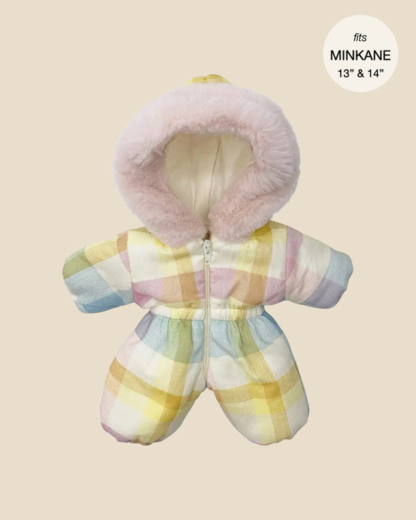 A chic winter snowsuit called the Pastel Plaid Ski Suit from Minikane Doll Clothing is designed to fit 13" and 14" Minikane Gordis dolls perfectly. It features a plaid pattern in pastel colors and a hood lined with soft pink faux fur trim.