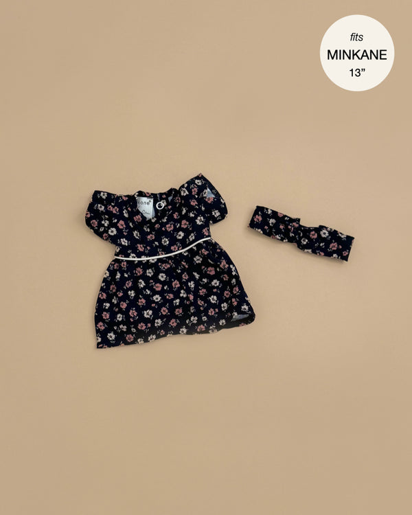 The Rylee+Cru Daisy Dress and Headband - Capucine, designed for 13" Minikane dolls, is a charming outfit laid out on a beige background—ideal for expanding your Minikane doll clothing collection.