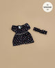 The Rylee+Cru Daisy Dress and Headband - Capucine, designed for 13" Minikane dolls, is a charming outfit laid out on a beige background—ideal for expanding your Minikane doll clothing collection.